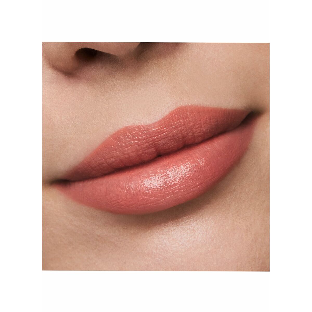 Close-up of a person's lips wearing a pink lipstick on a white background