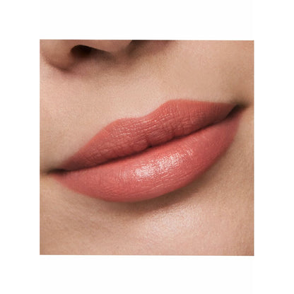 Close-up of a person's lips wearing a pink lipstick on a white background