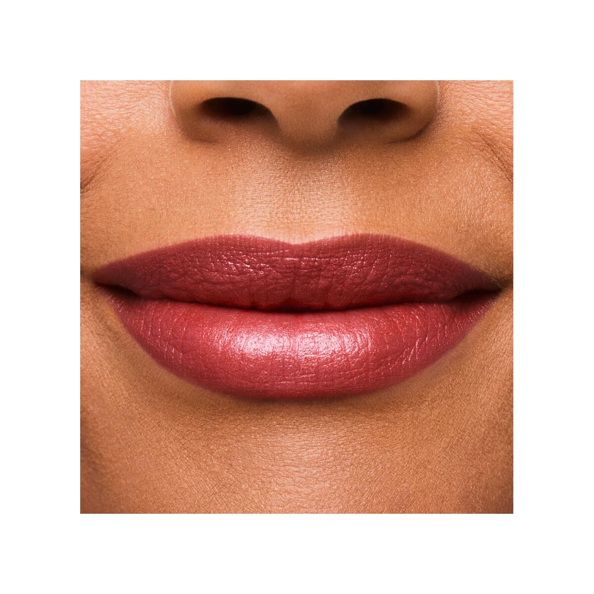 Close-up of a person's lips wearing a pink lipstick on a white background