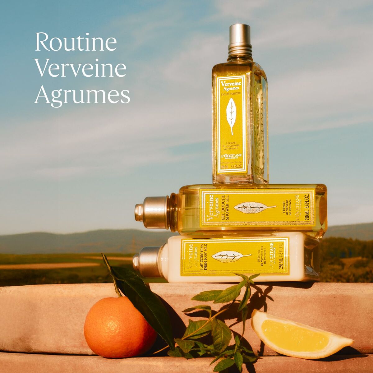Three bottles of Routine Verveine Agrumes products with a scenic background
