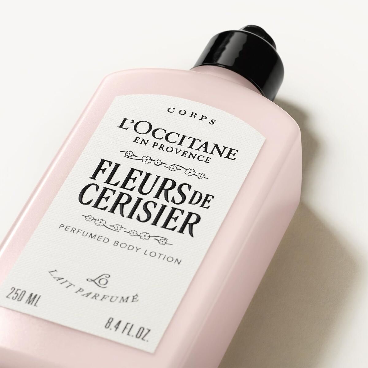 L'Occitane Fleurs de Cerisier body lotion bottle on a light background