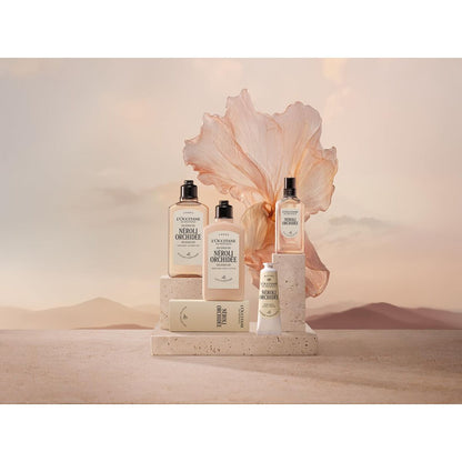 Cosmetic products with a large pink flower on a neutral background