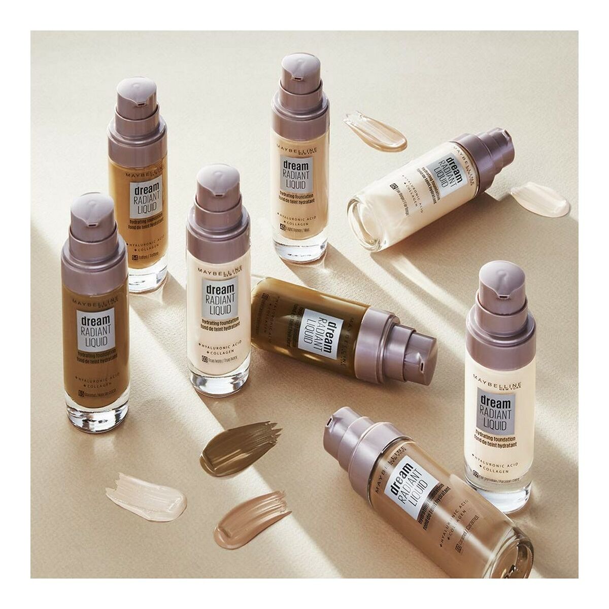 Cosmetic bottles with 'dream radiant liquid' on a beige background