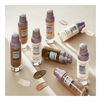 Cosmetic bottles with 'dream radiant liquid' on a beige background