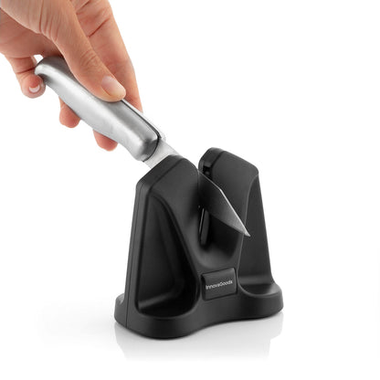 Knife sharpener with a hand holding a knife on a white background