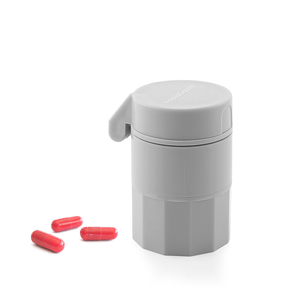 Gray pill container with pink capsules on a white background