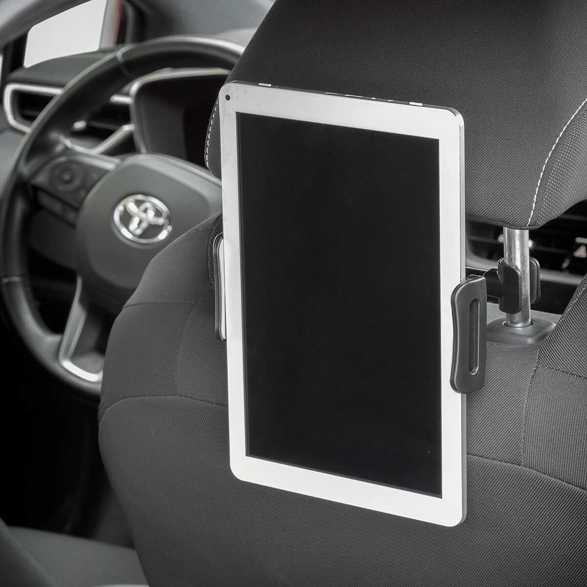 Tablet holder mounted on a car seat with a Toyota logo visible.